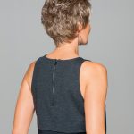 Short curly wig styled on a woman with short hair and earrings.