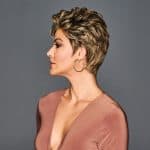 Short curly blonde wig styled on a woman with side profile view.