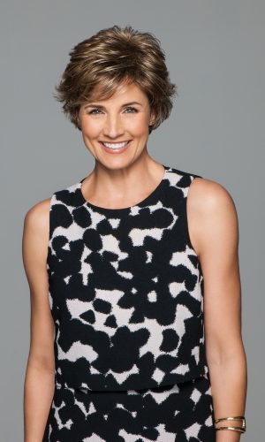 Woman with short, curly, layered wig in a stylish cut.