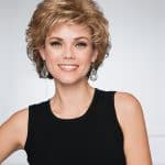Woman with short, curly blonde wig and black sleeveless top.