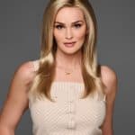 Beautiful blonde woman with long, straight hair wearing a beige top.
