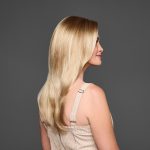 Blonde wavy wig styled on a woman with side profile view.