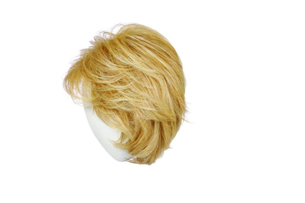 Blonde short layered wig on a white mannequin head.