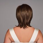 Back view of a woman with a natural brown layered wig.