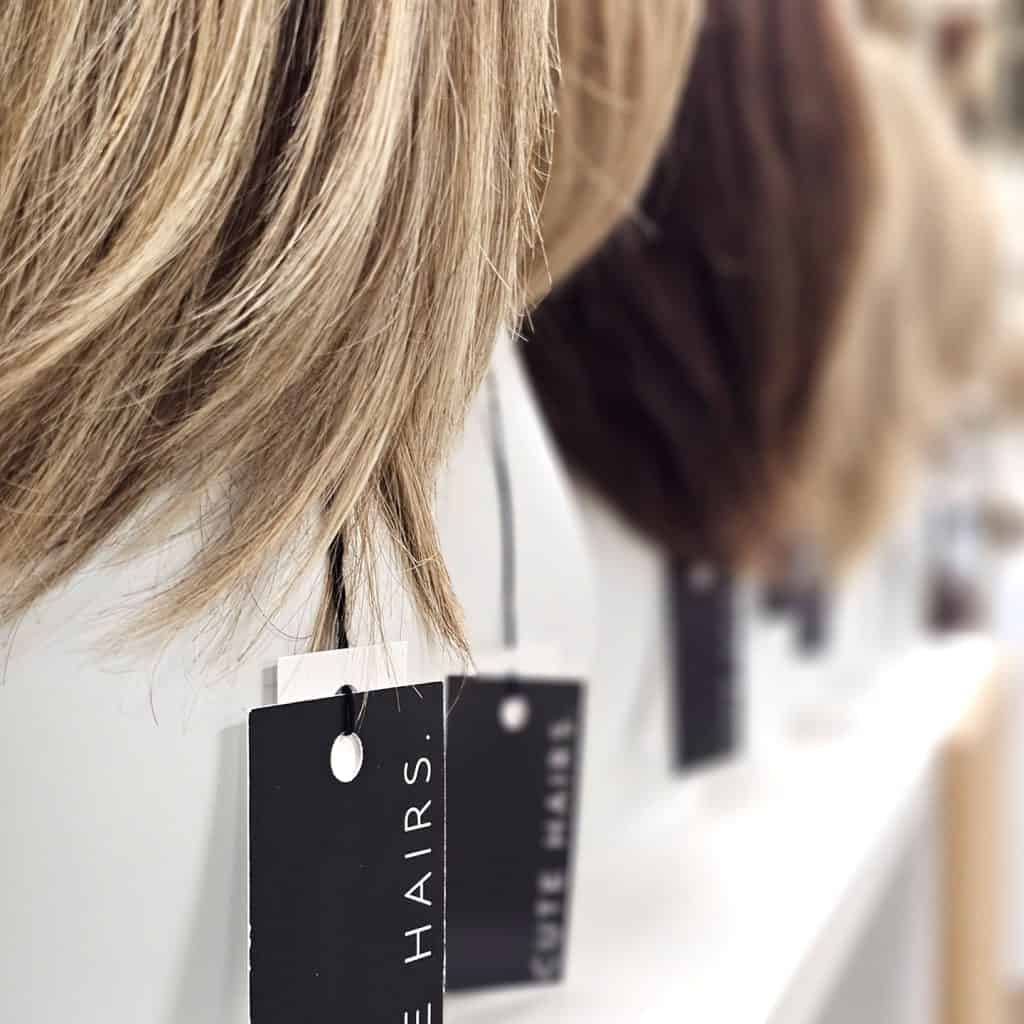 Display of wig samples at Hidden Secrets Wigs for fitting consultation.