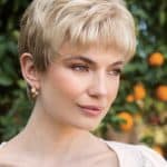 Blonde short wig with layered style, natural look, outdoors setting.
