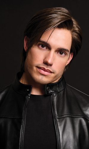Male model with Daring Elite wig, wearing black leather jacket.