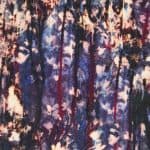 Colorful printed fabric with abstract patterns in blue, pink, and black tones.