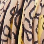 Close-up of a patterned wig with yellow and black animal print design.