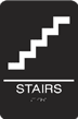 Accessible stairs sign with wheelchair symbol and stairs icon.
