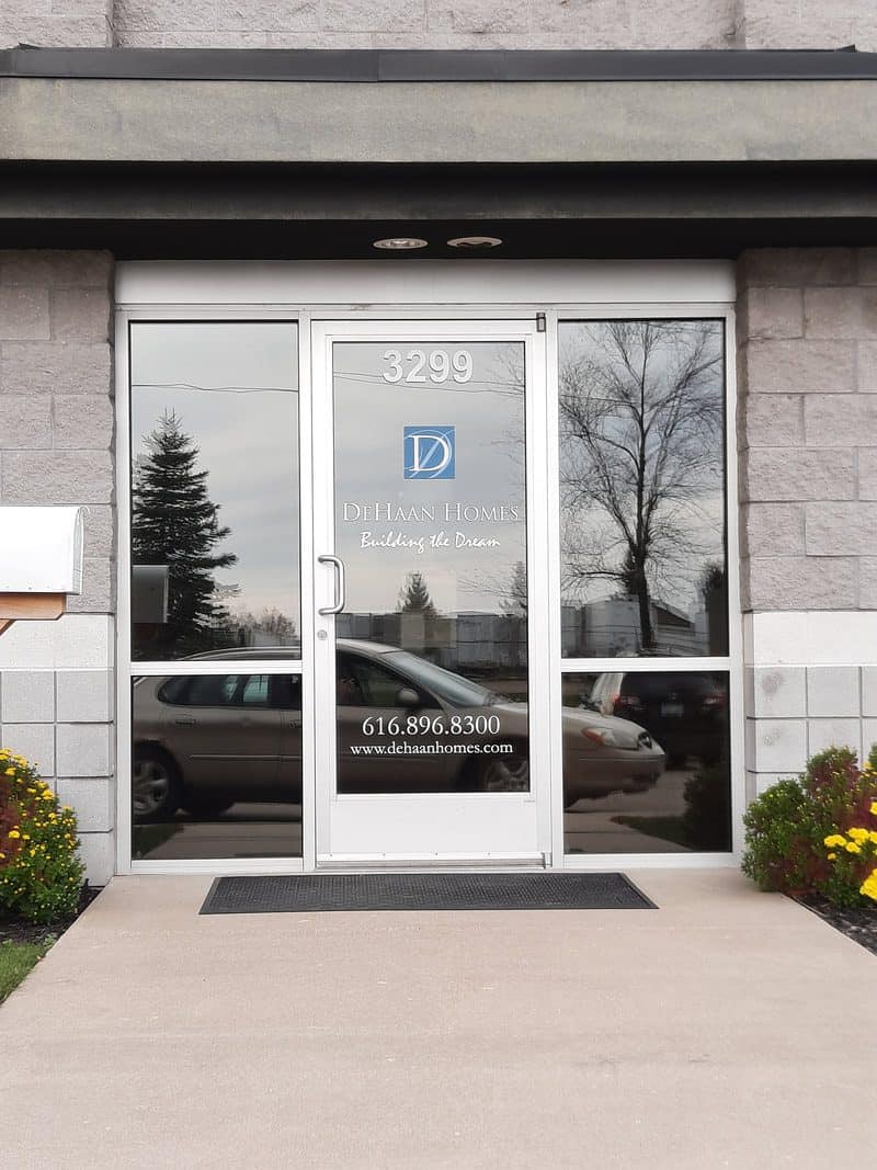 Glass door with company logo and contact info at Handicap Sign Inc.