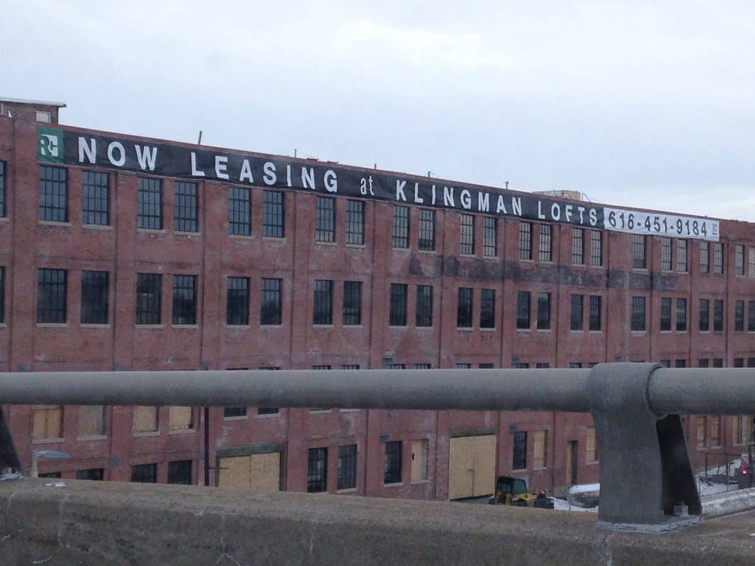 Now leasing sign at Klingman Lofts building with contact number.