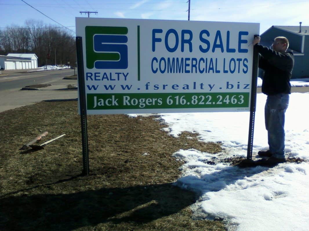 For sale sign advertising commercial lots by FS Realty with contact info.
