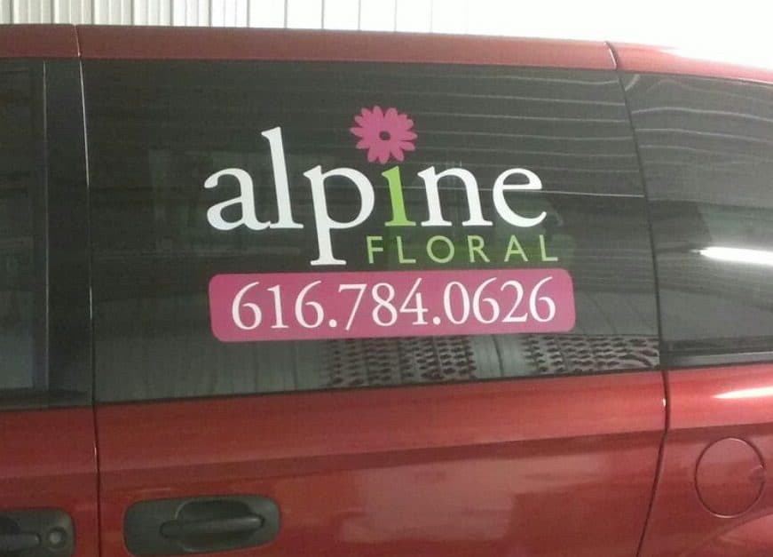 Business vehicle with Alpine Floral logo and contact number.
