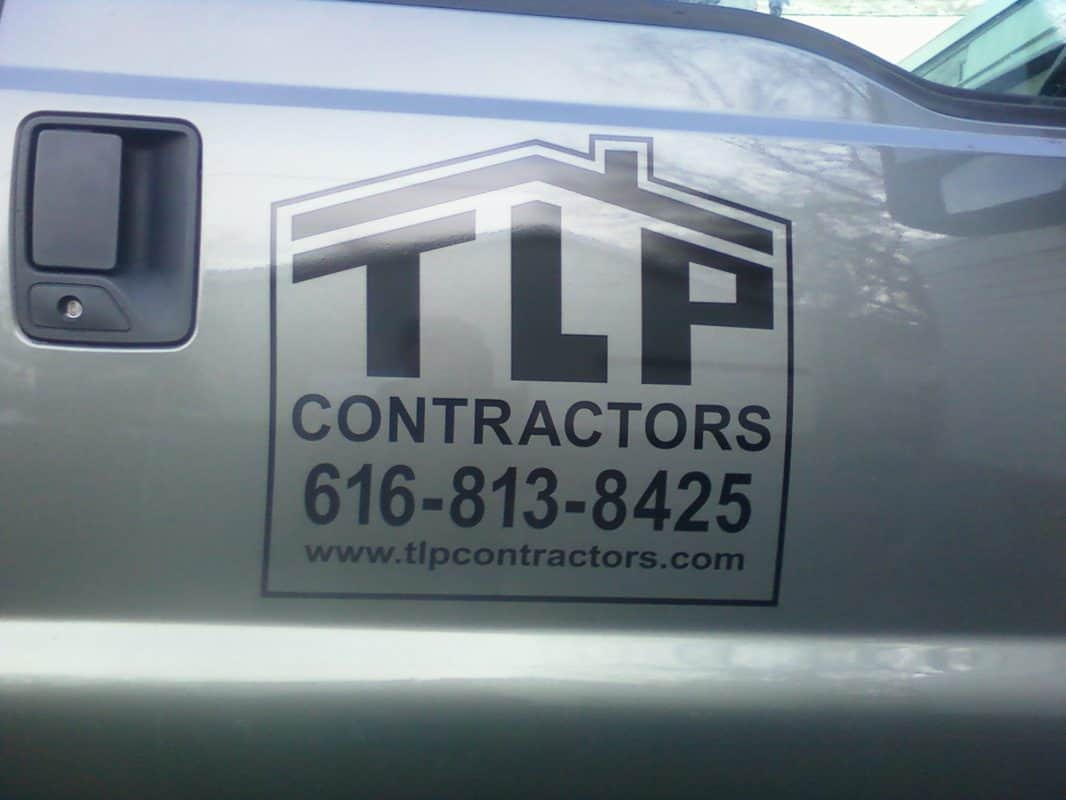 Vehicle decal for TLP Contractors with contact info and logo.