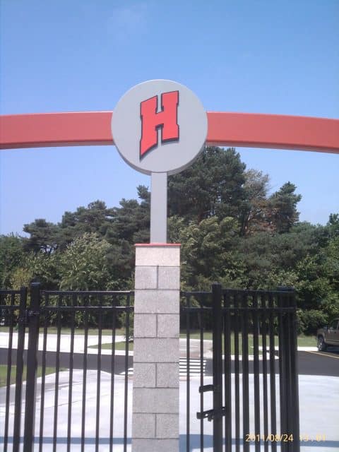 Large red 'H' handicap sign on an archway at entrance.