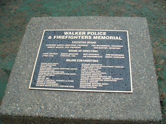Memorial plaque for Walker Police and Firefighters with names and contributions.