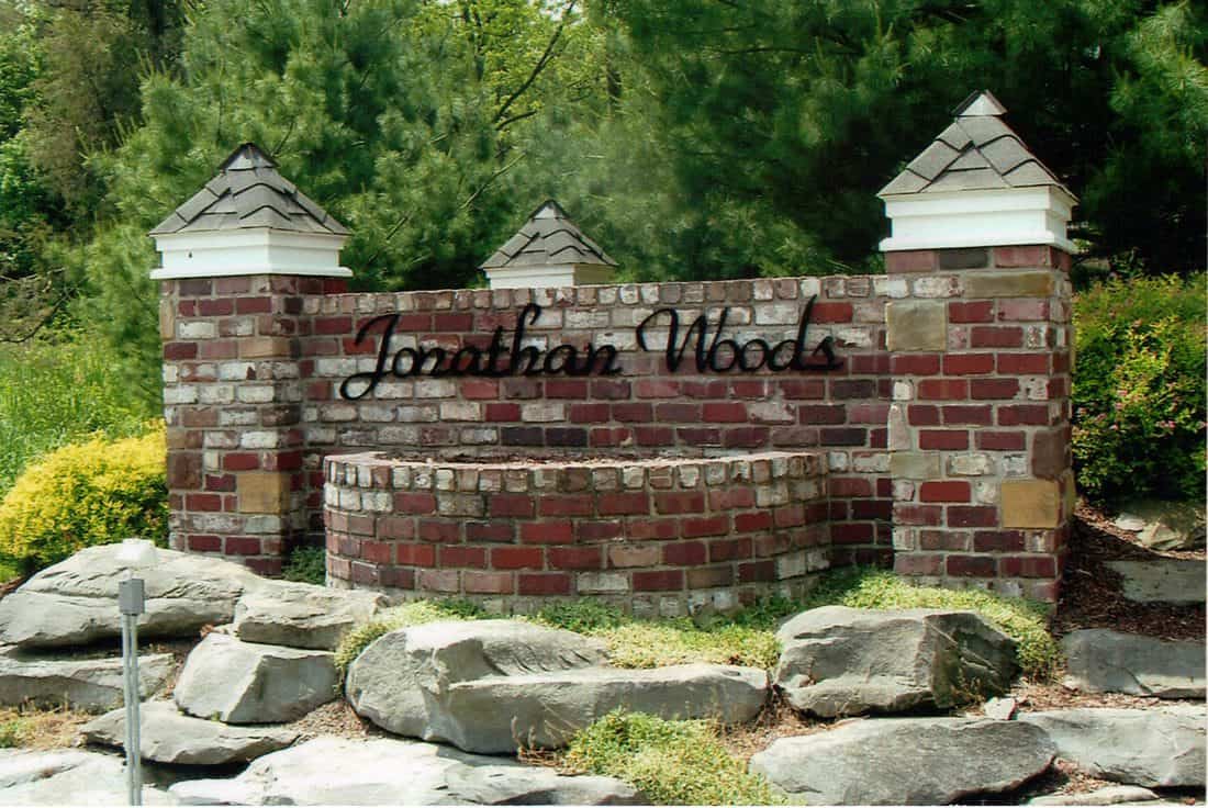 Brick entrance sign with black metal lettering for Jonathan Woods.