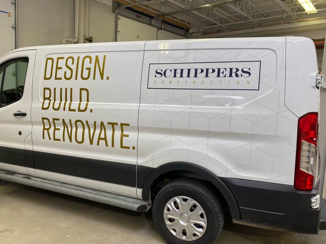 Construction van with Schippers Construction logo and design slogan.