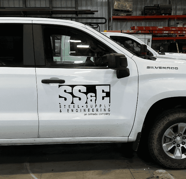 White Silverado truck with Handicap Sign Inc. logo on the door.