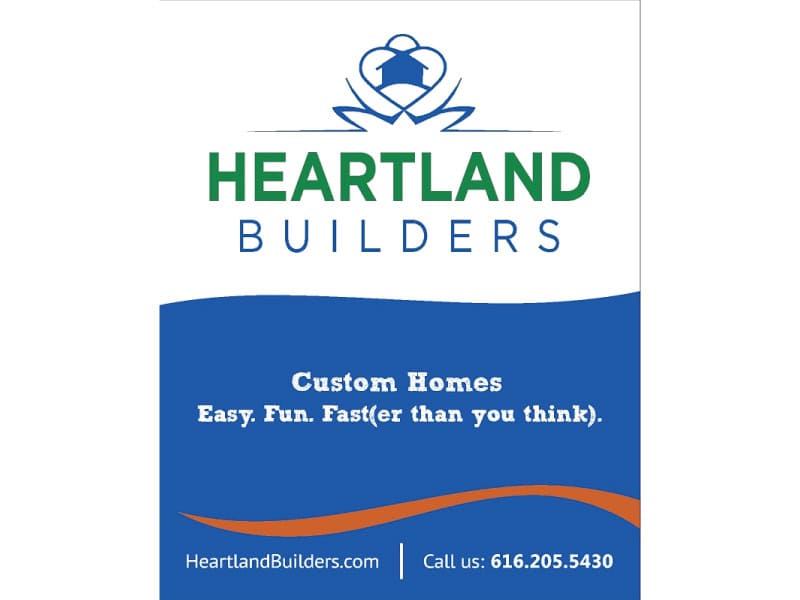 Custom homes sign by Heartland Builders with contact info and slogan.