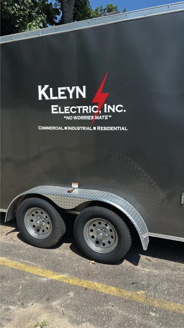 Service trailer with Kleyn Electric Inc. logo and dual axles.