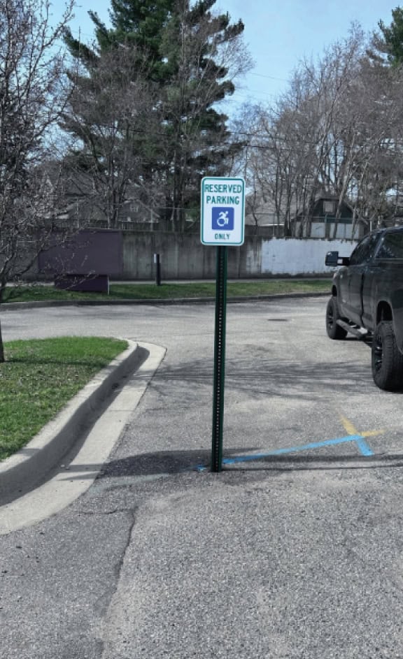 Reserved parking sign for handicapped accessible parking only.