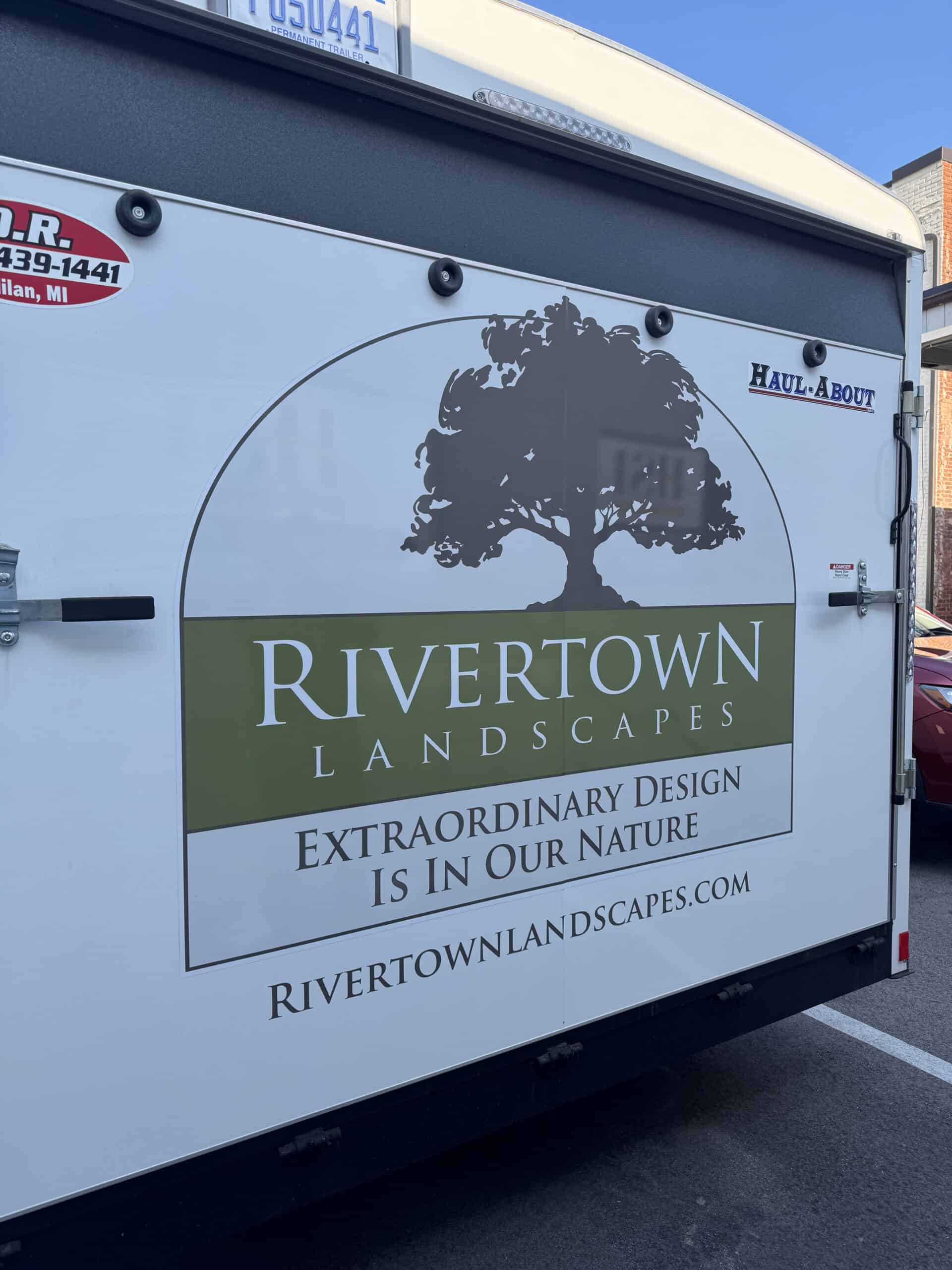 Vehicle wrap for Rivertown Landscapes with tree logo and company slogan.