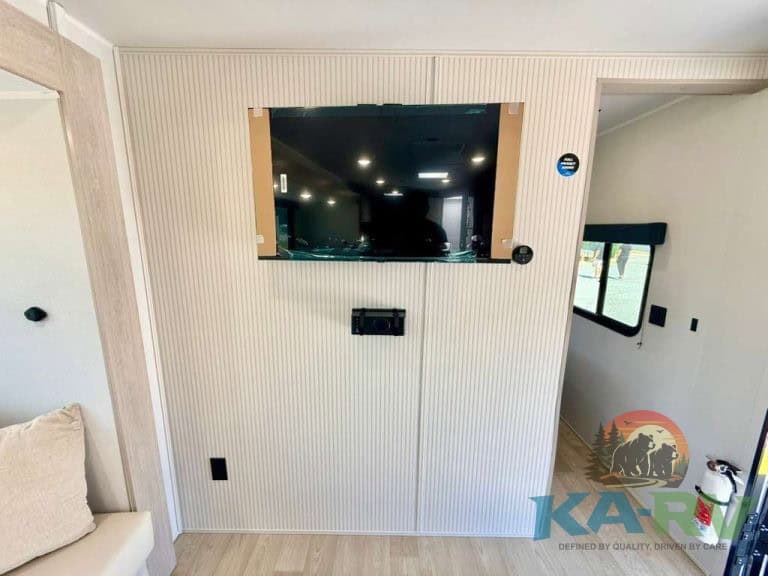 RV entertainment wall with TV and controls in 2026 Acclaim 2700BH.