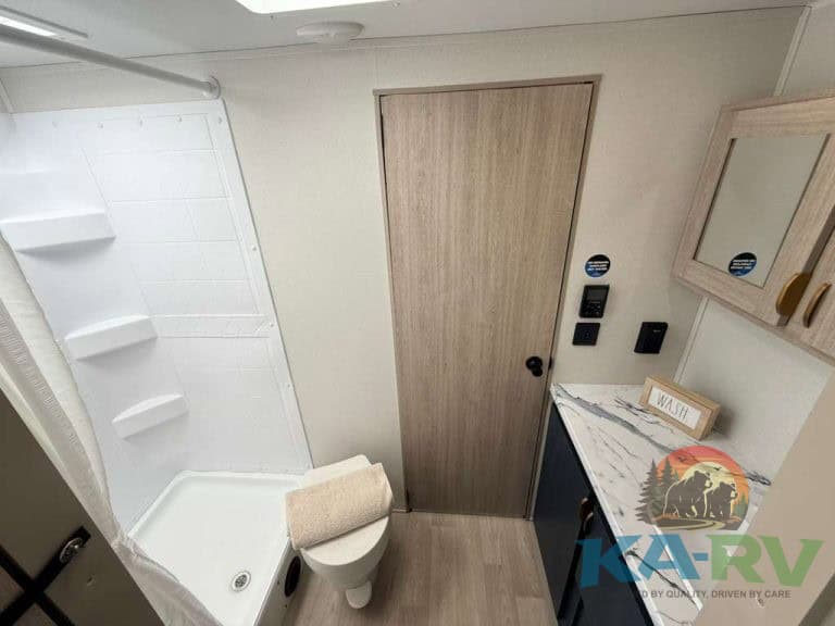 Interior view of a 2026 Acclaim 2500RD RV bathroom and vanity area.