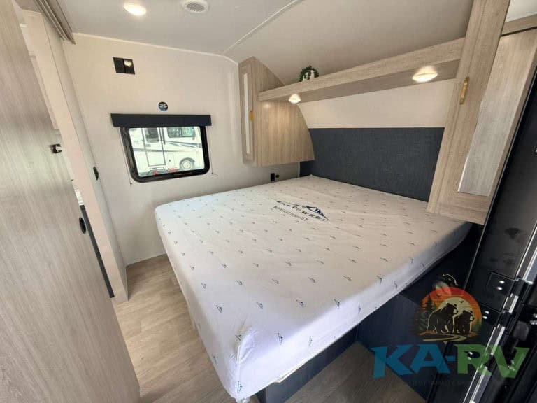 Interior of 2026 Acclaim 2500RD RV with bed and storage.