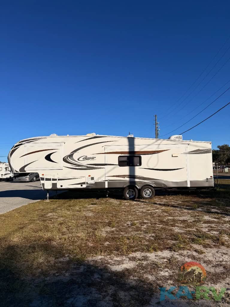 Keystone Cougar 331MKS travel trailer parked outdoors for repair services.