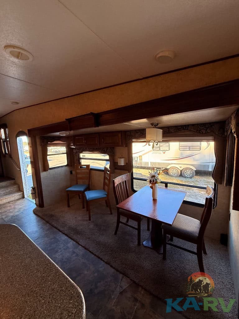 Interior view of the dining area in a 2014 Keystone Cougar 331MKS RV.