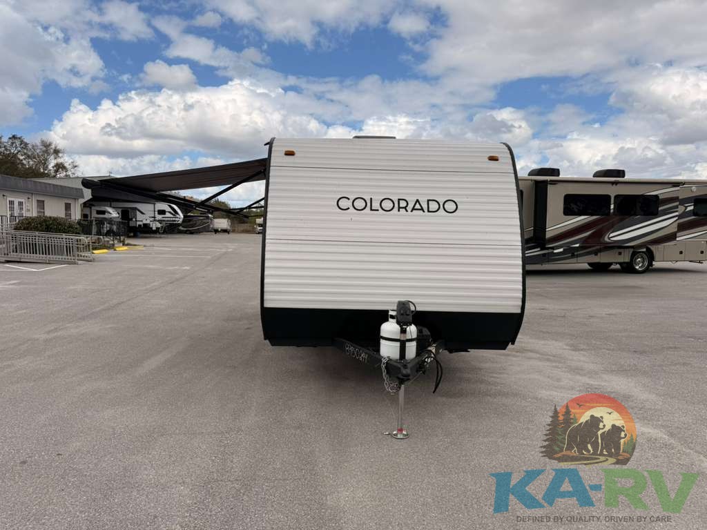Keystone Colorado 17RBC travel trailer with awning in outdoor lot.
