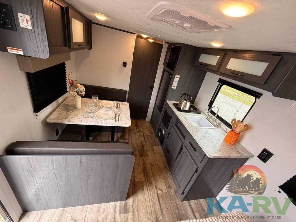 Interior view of Keystone Colorado 17RBC RV with kitchen and dining area.