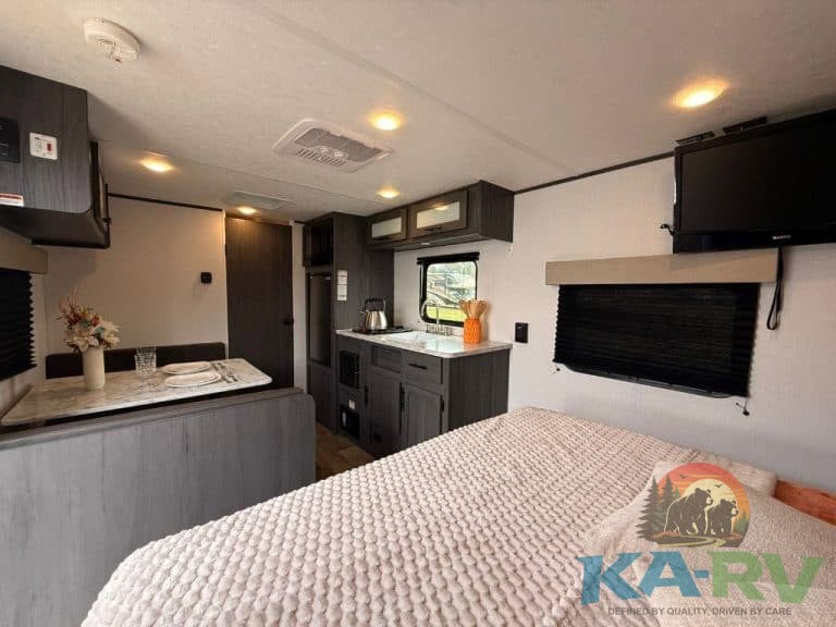 Interior of Keystone Colorado 17RBC RV with kitchen and sleeping area.