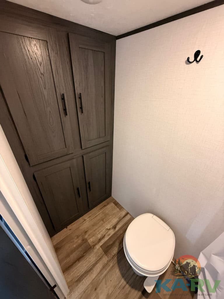 Bathroom cabinet and toilet in Keystone Colorado 17RBC RV.