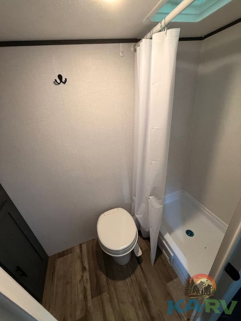 Bathroom in Keystone Colorado 17RBC RV with shower and toilet.