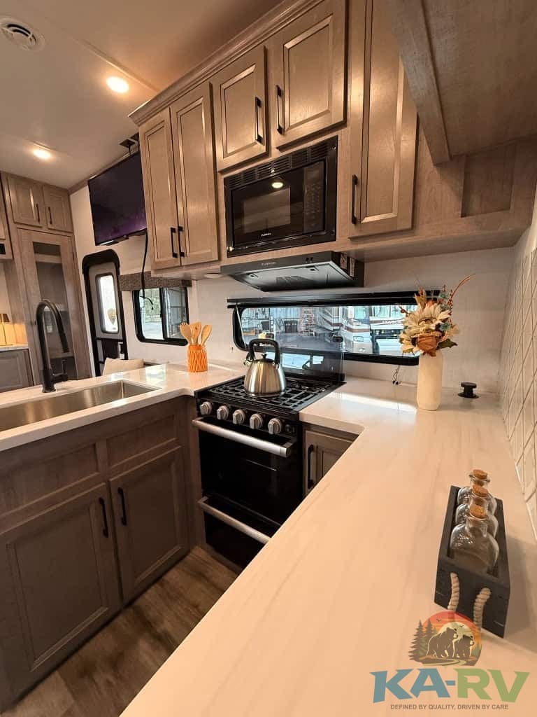 Efficient RV kitchen with modern appliances for Dutchmen Voltage 3800. Perfect for travel and campin.