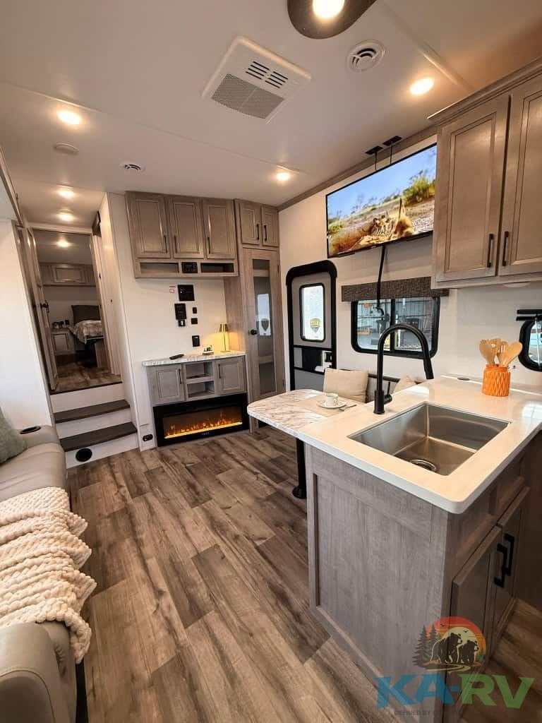 Interior view of the 2025 Dutchmen Voltage RV with modern kitchen and living space.
