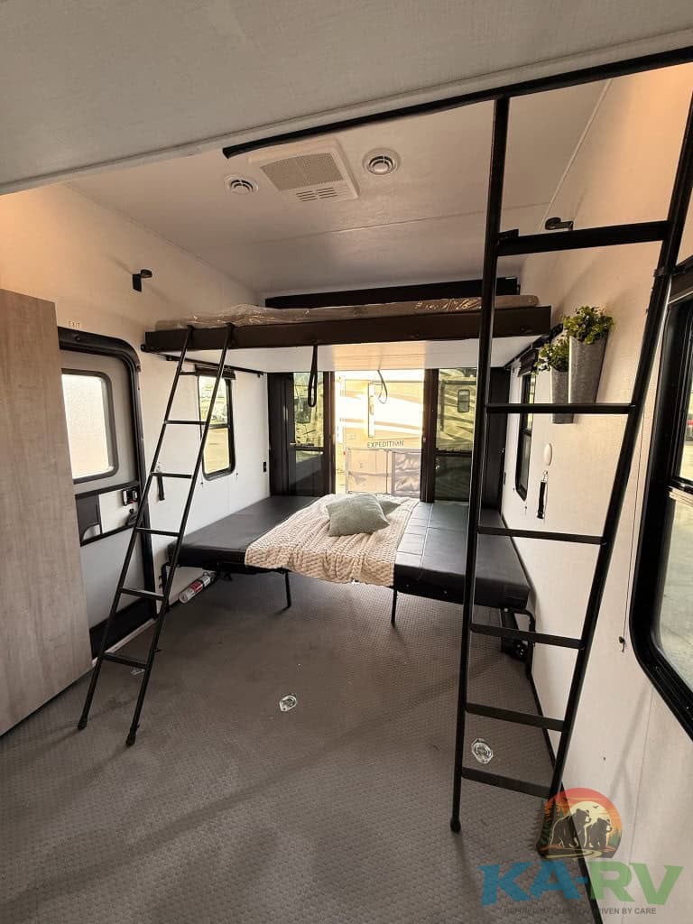 Bunk beds inside a 2025 Dutchmen Voltage RV, optimized for space and comfort.
