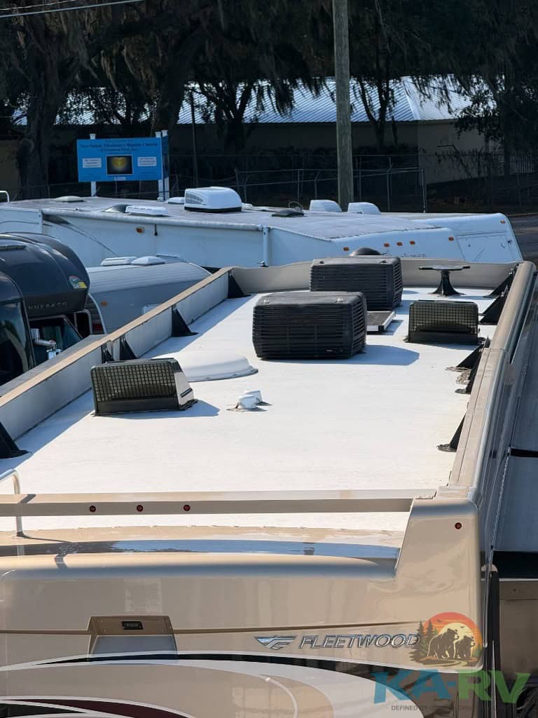 RV roof with air vents, solar panels, and skylights for optimal energy efficiency.