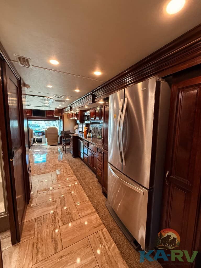 High-quality kitchen with stainless steel appliances in a luxury RV.