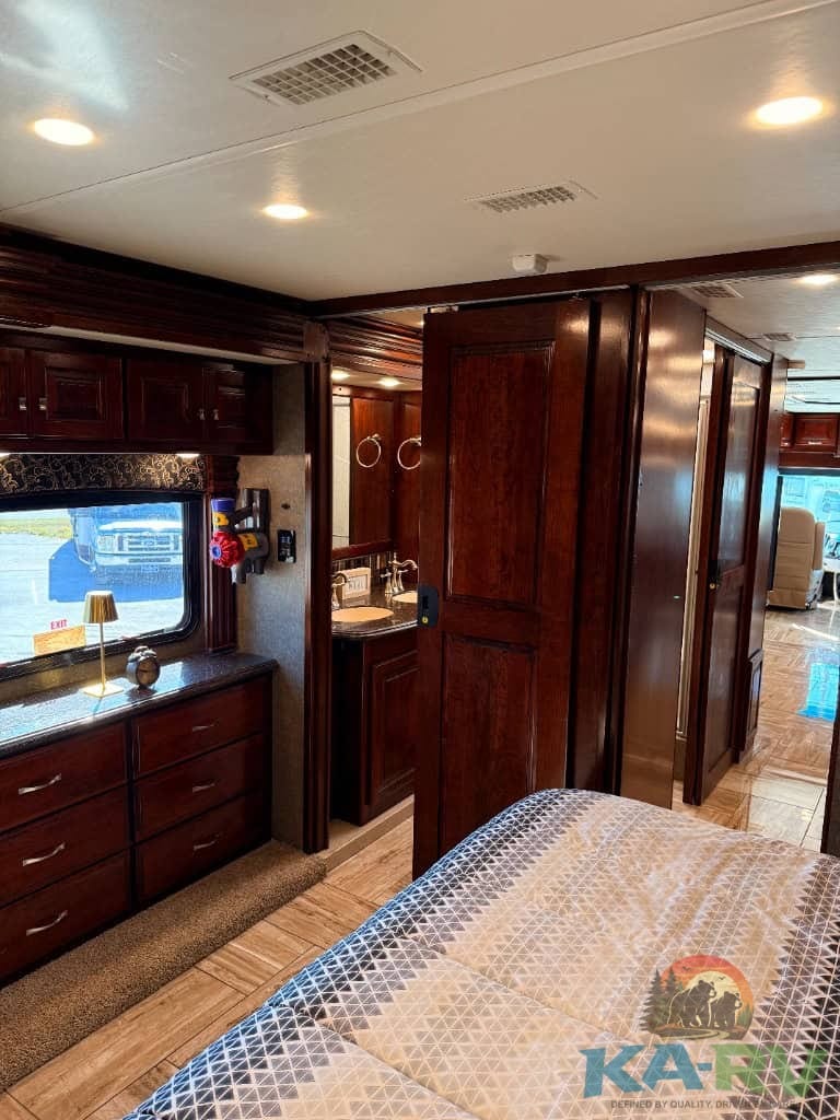 Accessible RV bedroom with wooden cabinetry and modern amenities.