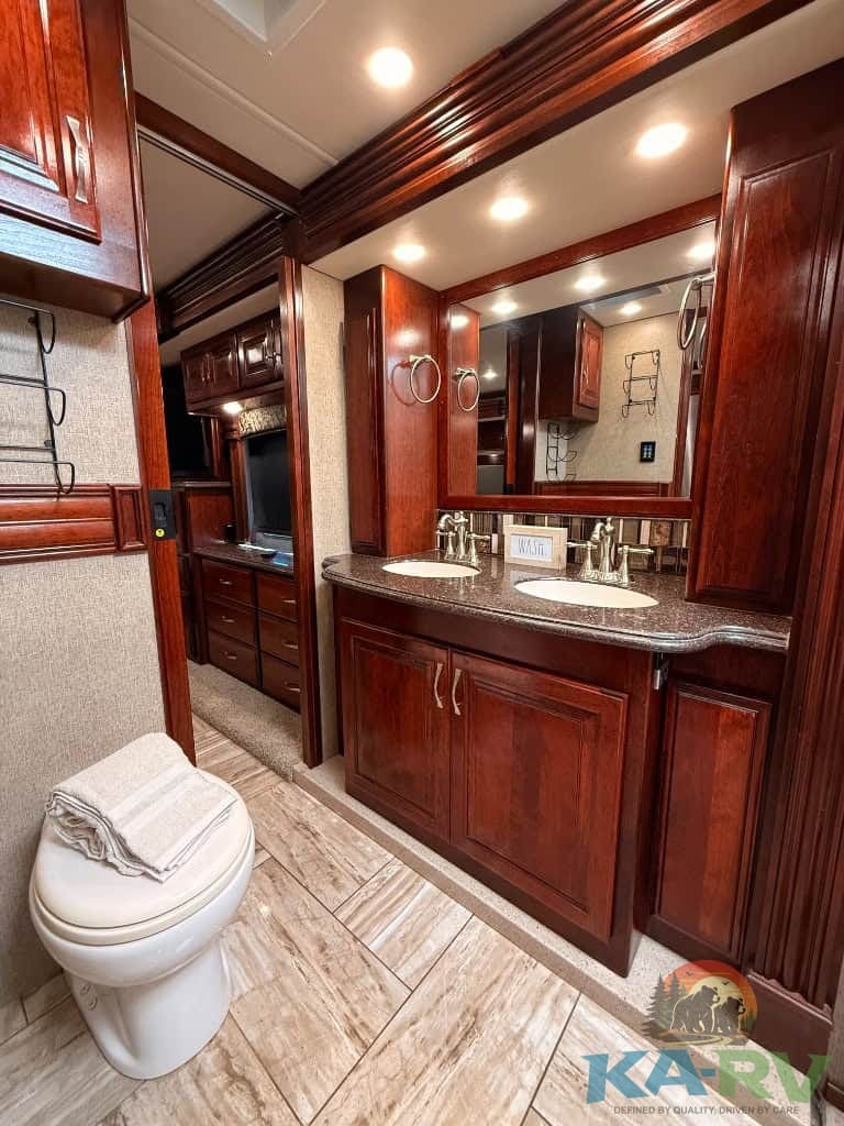 Luxury RV bathroom with wooden cabinetry and modern fixtures.