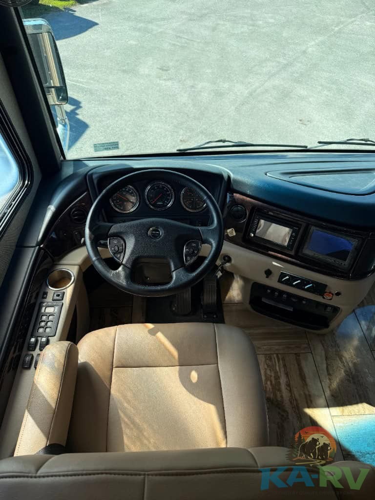 RV dashboard interior with steering wheel and control panel for optimal vehicle operation.
