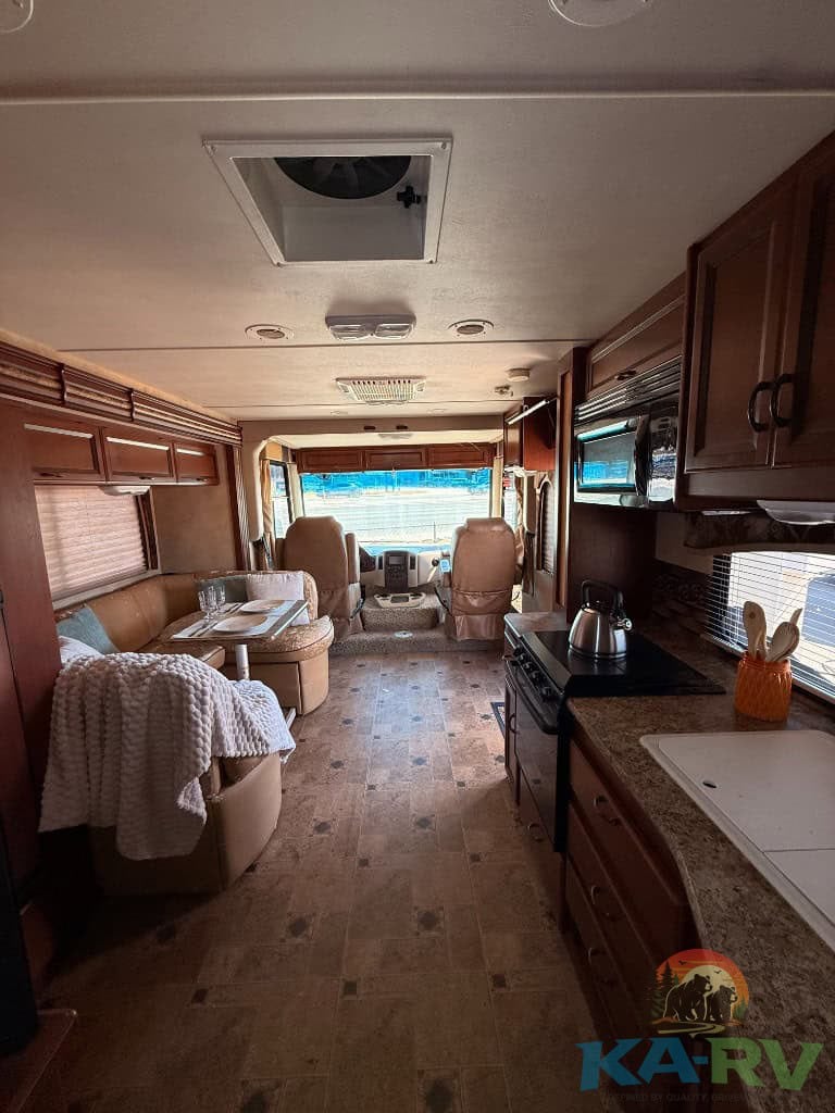Interior view of a 2013 Four Winds Hurricane RV showing living and kitchen areas.