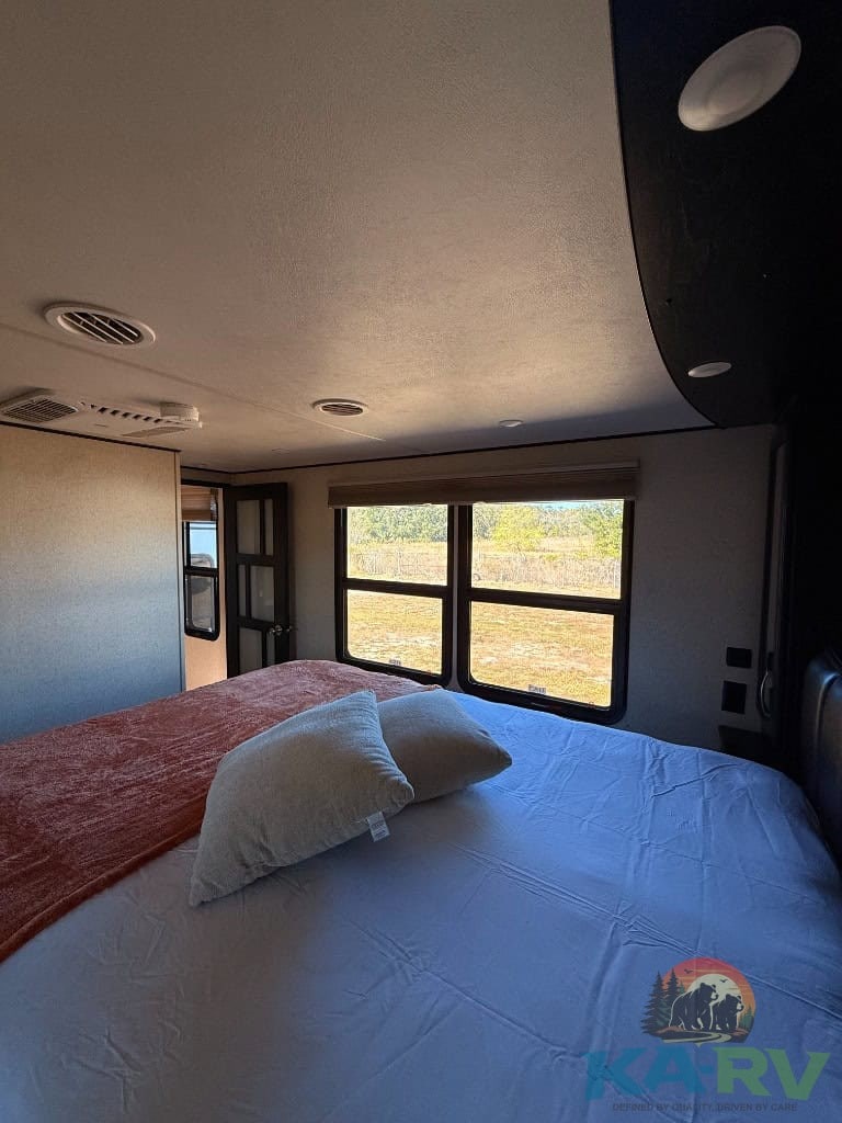 Enhanced image of a bedroom in a 2017 Grand Design Momentum RV.