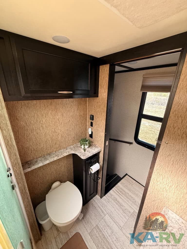 Accessible RV bathroom with modern fixtures and storage.