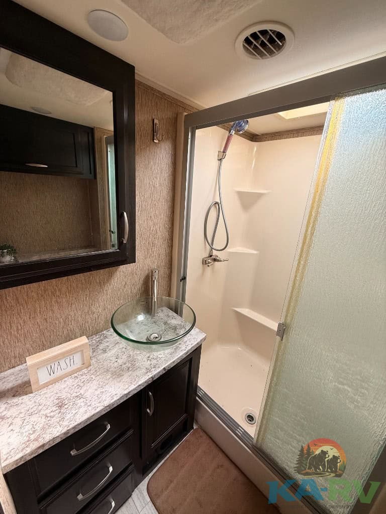 Efficient bathroom setup in a 2017 Grand Design Momentum 376TH RV.